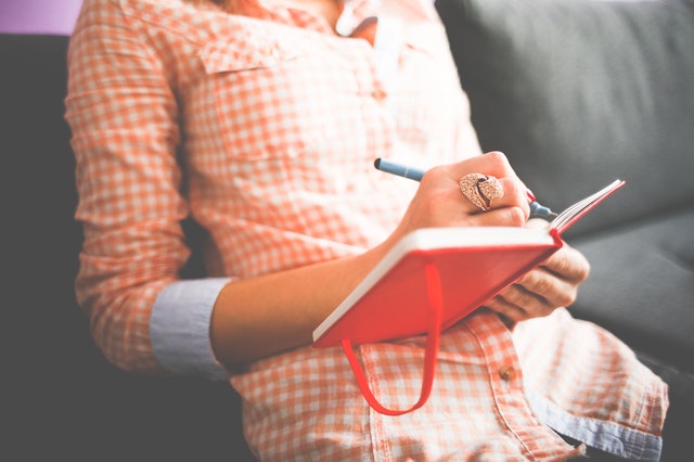 a woman taking down notes