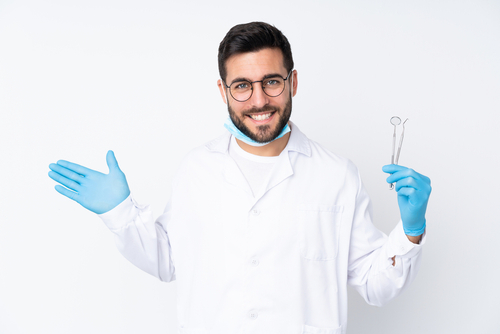 dentist holding dental tools - featured image