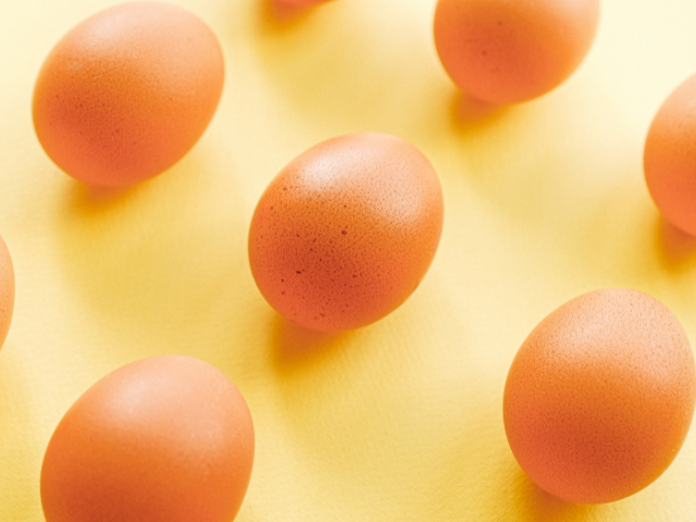 brown eggs in yellow background