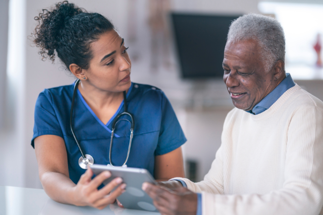 nurse and elderly patient chatting