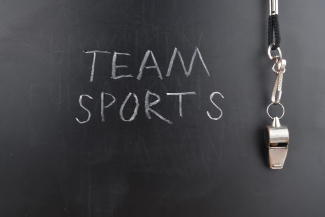 Team Sports sign with a whistle on black background