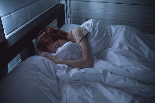 a woman sleeping soundly in bed