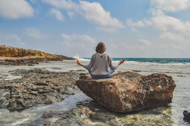 practicing relaxation technique by the seashore