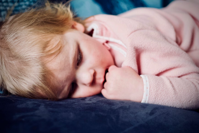 toddler lying on his tummy - featured image