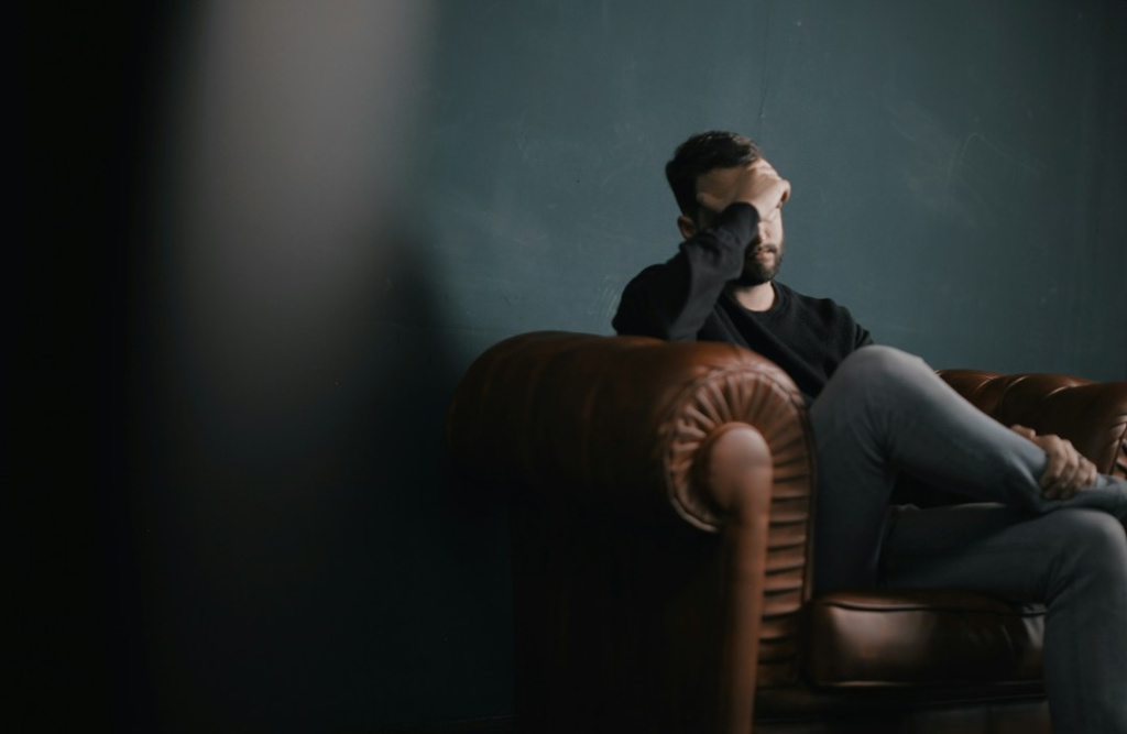 man sitting in the darkness - featured image