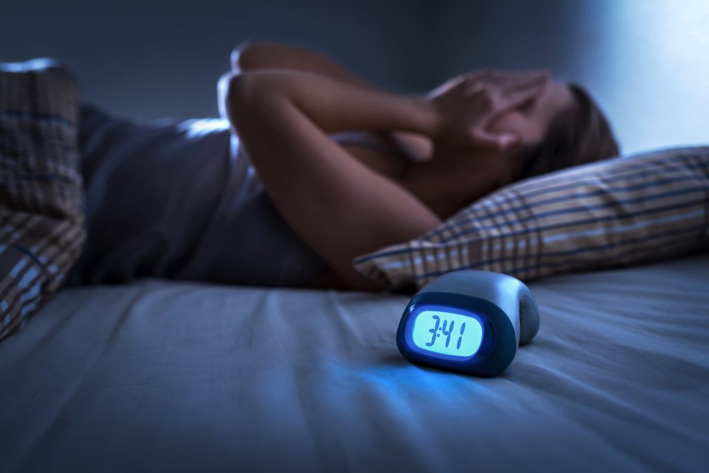 Sleepless woman suffering from insomnia, sleep apnea or stress.