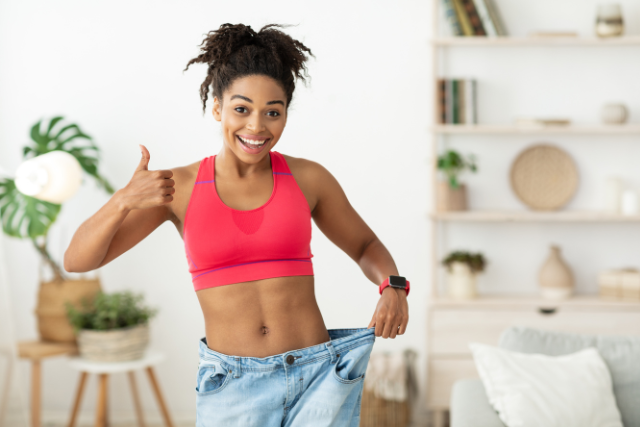 young female flexing her weight loss success - featured image
